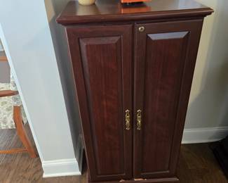 Locking cherry VHS tape cabinet with key, holds 128 tapes