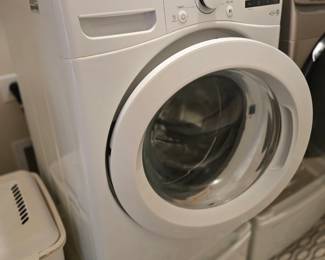 LG frontload washer with white storage pedestal