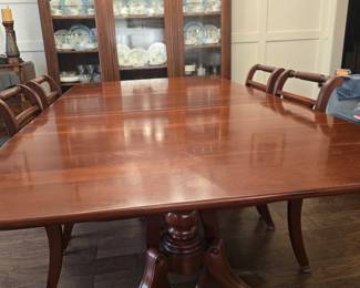 Cherry Duncan Phyfe dining table with 6 chairs (china, crystal and silver pieces in background)