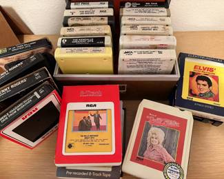 Collection of vintage media including 8-track & cassette tapes, CDs, cassette tapes, VHS movies