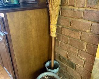 Straw hearth broom in blue glazed ceramic planter pot