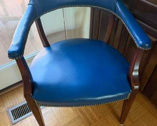 Blue leather barrel back captain's chair with nailhead trim