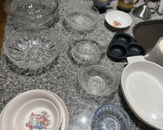 Pressed glass bowls, oval platters, muffin pan and decorated ceramic plates