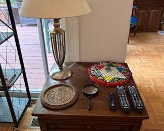 Wood side table with brass table lamp, Chinese checkers board and carved wood tray