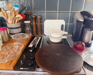 Kitchen counter with wood utensils in crock, pepper mills, cutting boards, wood lazy Susan and Keurig coffee maker