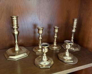 Collection of six brass candlesticks in graduated sizes