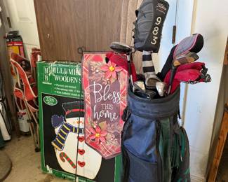 Golf clubs in bag with Christmas snowman garden flags