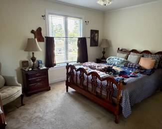 Bedroom set with carved spindle bed, nightstands, table lamps and upholstered armchair