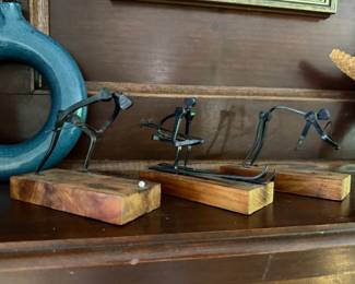 Set of three metal wire sculpture figures on wood block bases