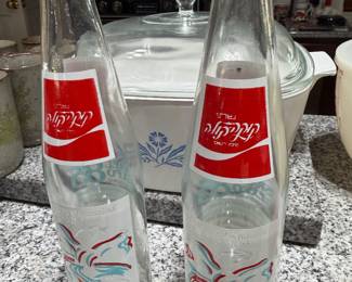 Pair of vintage Hebrew label Coca-Cola glass bottles with Corning Ware Cornflower casserole