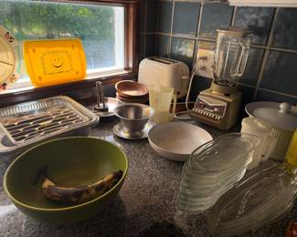 Kitchen lot with blender, toaster, glass plates, mixing bowls, baking pans and ceramic canister
