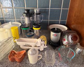 Kitchen lot with French press, copper measuring cups, glass pitcher, candles, ceramic dish and glass bakeware