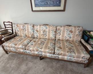 Vintage wood frame sofa with floral upholstered cushions