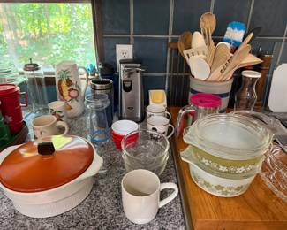 Vintage Pyrex green floral casserole with lid, orange lidded casserole, stoneware mugs and glass measuring cups