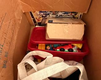 Box with red storage bin of die-cast toy cars and canvas tote bag