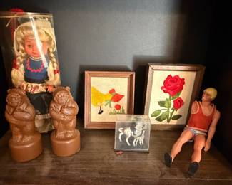 Collectible doll in tube case, carved figural bookends, framed needlework and vintage doll