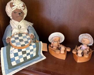 Quilting bear figurine with patchwork quilt and pair of bonnet figurines