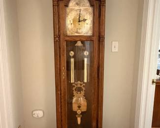 Oak grandfather clock with brass weights and pendulum