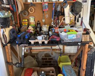 Garage workbench with pegboard tool storage, hand tools and hardware bins