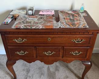 Queen Anne style cherry lowboy chest with brass pulls and cabriole legs