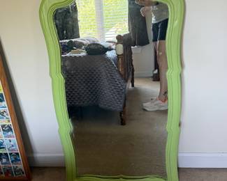 Painted green wood framed wall mirror with carved crest