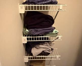 Closet shelving with folded clothing and linens