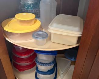Corner cabinet lazy Susan with Tupperware and assorted food storage containers