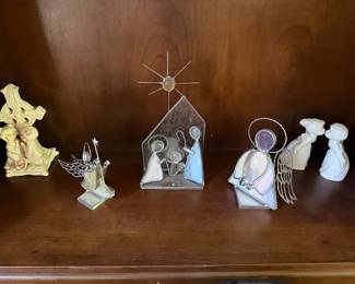 Stained glass nativity scene, angel figurines and ceramic cross
