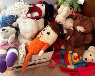 Box of stuffed animals and cloth dolls including teddy bears and rag dolls