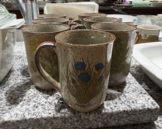 Set of vintage stoneware mugs with brown drip glaze and blue floral pattern