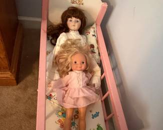 Painted wood doll cradle with two vintage dolls