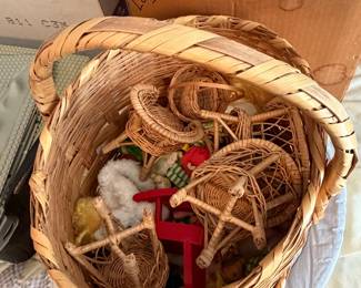 Large woven basket filled with wicker baskets and holiday decorations