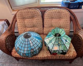Rattan loveseat and stained glass shades
