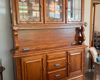 Oak roll top lighted breakfront