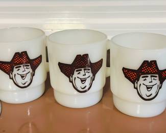 vintage Anchor Hocking Fire-King milk glass coffee mugs featuring the Farmer Jack cowboy advertising logo