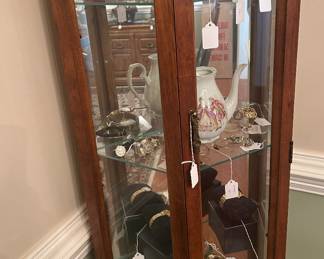 Glass fronted case with a large collection of wristwatches
