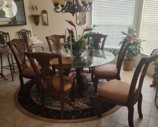 Large Round glass top dining room table and 6 chairs