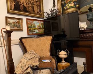 French wing chairs, antique carved wood mantle, TVs, andirons, art,