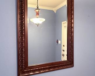 Ornate Wall Mirror– Large rectangular wall mirror featuring an intricately carved wood frame with decorative detailing. A timeless accent piece for an entryway, living room, dining room, or bedroom. Sold as found.
