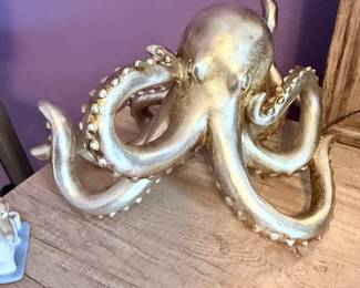 **Decorative Octopus Sculpture** – Metallic finish octopus sculpture featuring detailed tentacles and a contemporary design. A unique coastal-inspired accent for a shelf, tabletop, or office. Sold as found.