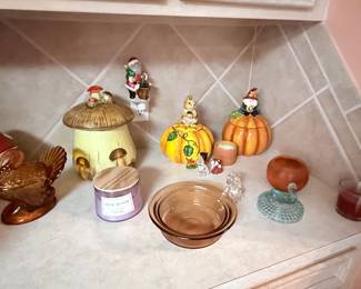 **Kitchen Décor Collection** – Decorative ceramic mushroom cookie jar, turkey candy dish, pumpkin candle holders, seasonal figurines, candle, baking dish, and assorted fall and holiday décor. Items sold individually unless noted.