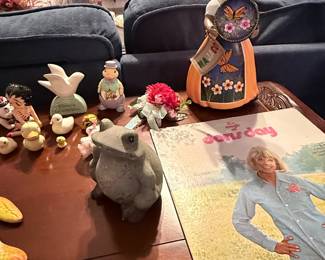Assortment of home décor and collectibles including a Doris Day record album, Disney collectibles, decorative figurines, floral arrangement, ceramic bird, frog figurine, and tabletop accents. Items sold individually unless noted.