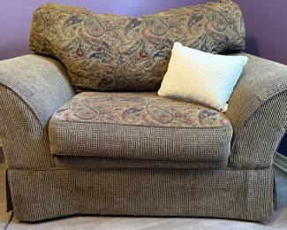 Oversized Upholstered Chair – Oversized upholstered chair featuring rolled arms, a paisley back cushion, and textured coordinating fabric. A comfortable seating option for a living room, bedroom, or reading nook. Sold as found.