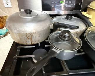 **Magnalite Cookware** – Vintage Magnalite aluminum stock pot with lid, shown alongside additional pots and pans. A sought-after cookware brand known for its durability and even heat distribution. Items sold individually unless noted.