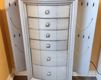 Jewelry Armoire – Tall jewelry armoire featuring six drawers and a hinged side compartment design for organizing jewelry and accessories. Finished in a distressed gray wood tone with decorative hardware. A stylish and functional storage piece for a bedroom or dressing area. Sold as found.