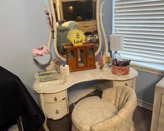 Vintage Vanity Set – Elegant vanity featuring a decorative framed mirror, curved drawers, and a marble-look top, paired with a upholstered vanity chair. A beautiful addition to a bedroom or dressing area with classic vintage-inspired style. Items sold individually unless noted.