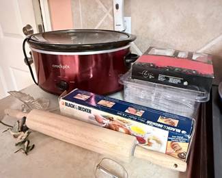 Kitchen Essentials Collection – Crock-Pot slow cooker, Black+Decker vacuum sealer rolls, baking pans, rolling pin, hand mixer beaters, and assorted kitchen accessories. A practical collection for everyday cooking and baking. Items sold individually unless noted.
