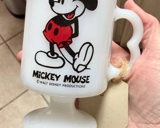 **Vintage Mickey Mouse Milk Glass Pedestal Mug** – Vintage Walt Disney Productions milk glass pedestal mug featuring Mickey Mouse artwork and an easy-grip handle. A fun collectible for Disney fans or vintage mug collectors. Sold as found.