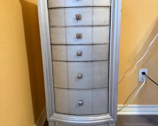 Jewelry Armoire – Tall jewelry armoire featuring six drawers and a hinged side compartment design for organizing jewelry and accessories. Finished in a distressed gray wood tone with decorative hardware. A stylish and functional storage piece for a bedroom or dressing area. Sold as found.