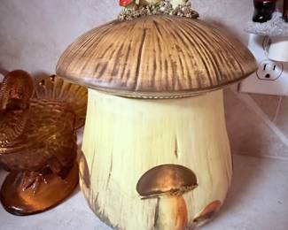 **Vintage Mushroom Cookie Jar** – Ceramic cookie jar shaped like a woodland mushroom with hand-painted mushroom accents on the lid and base. A charming vintage kitchen collectible or decorative accent. Sold as found.